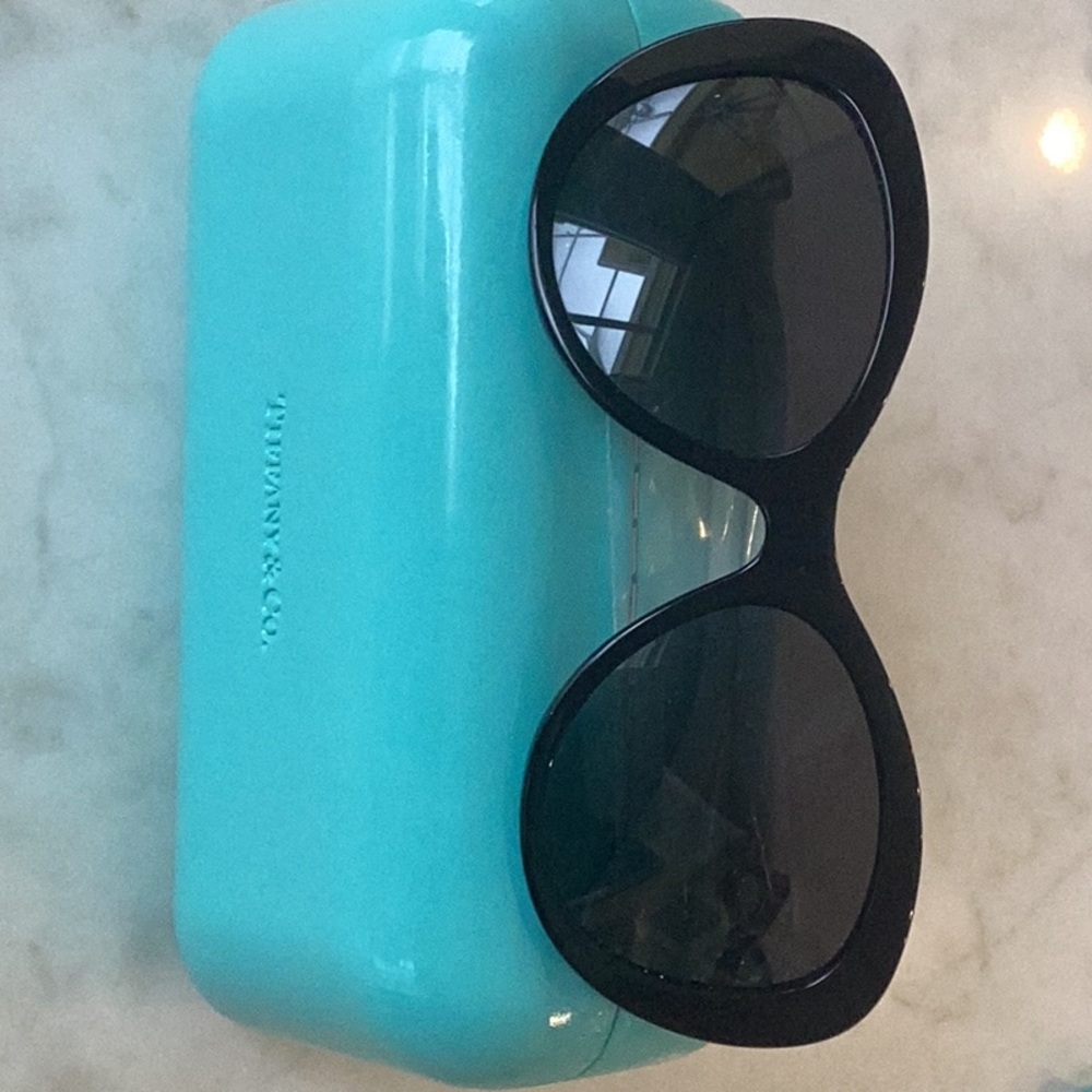 Tiffany Cat Eye sunglasses with dark lenses and bow motif on arms.